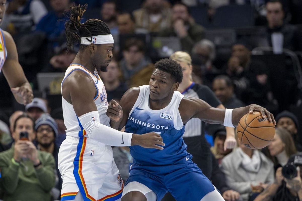 Nov 28, 2023; Minneapolis, Minnesota, USA; Minnesota Timberwolves guard Anthony Edwards (5) backs toward the basket as Oklahoma City Thunder guard Luguentz Dort (5) plays defense in the first half at Target Center.