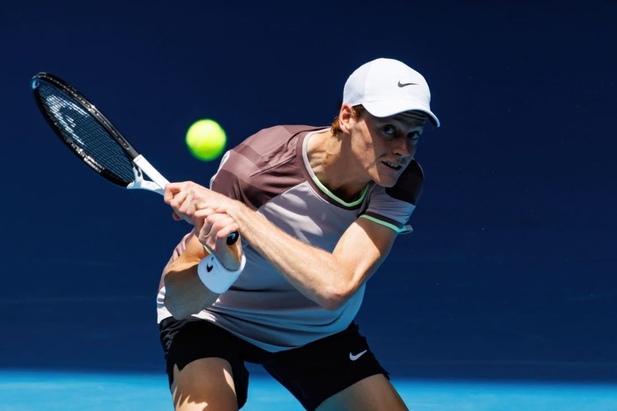 Jan 14, 2024; Melbourne, Victoria, Australia;   Jannik Sinner of Italy hits a shot against Botic Van De Zandschulp of the Netherlands in the first round of the men s singles.