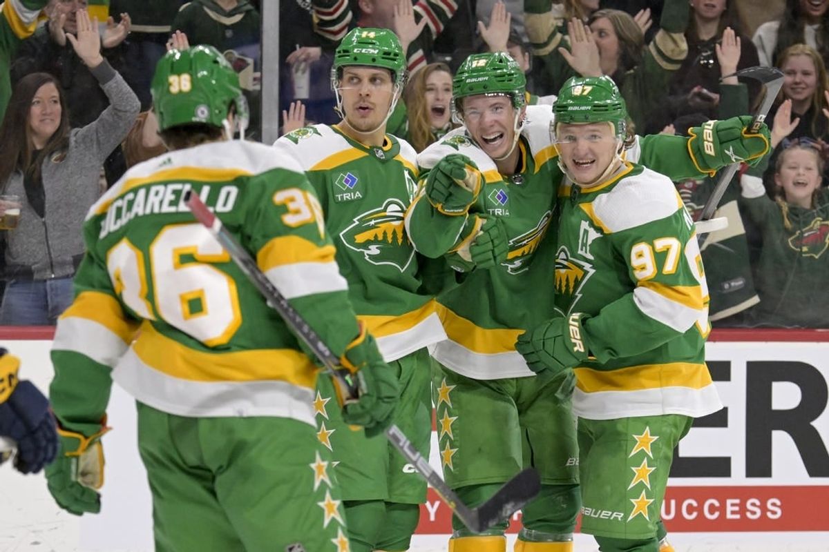 Mar 10, 2024; Saint Paul, Minnesota, USA;  Minnesota Wild forward Matt Boldy (12) points to forward Mats Zuccarello (36) who assisted on his overtime game-winning goal against the Nashville Predators as he celebrates with forward Joel Eriksson Ek (14) and forward Kirill Kaprizov (97) at Xcel Energy Center.