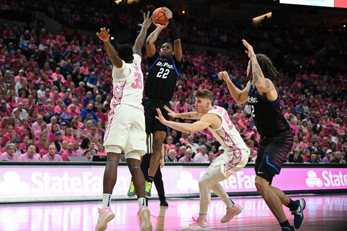 Jan 27, 2024; Omaha, Nebraska, USA; DePaul Blue Demons guard Elijah Fisher (22) attempt a shot against Creighton Bluejays center Fredrick King (33) in the first half at CHI Health Center Omaha.