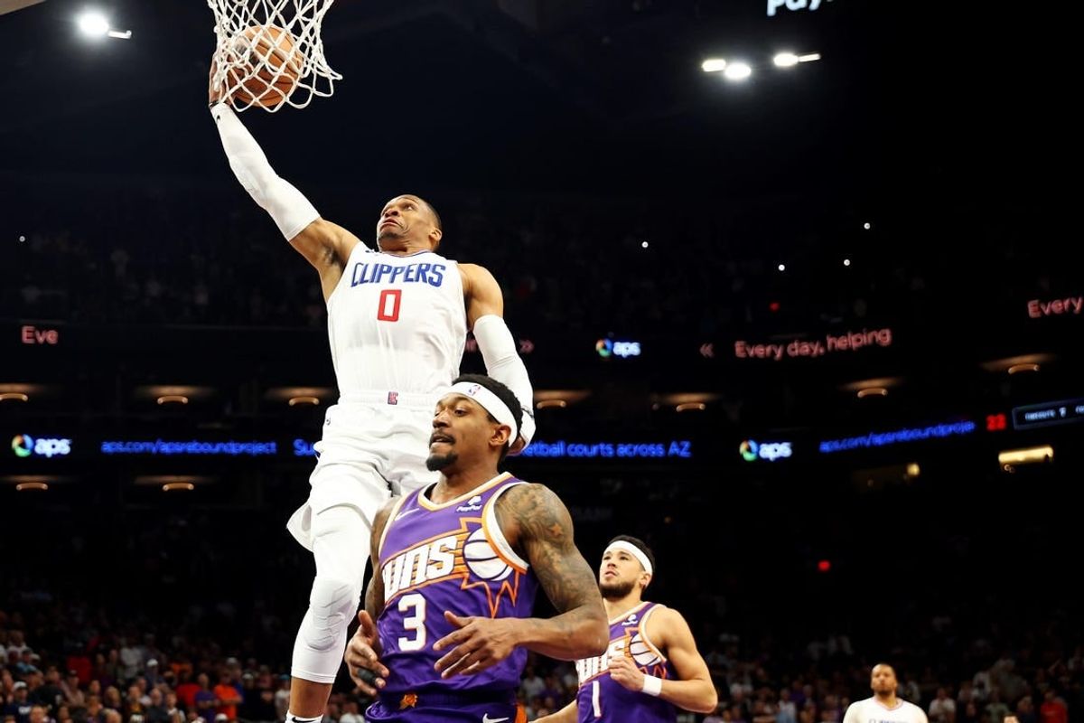 Apr 9, 2024; Phoenix, Arizona, USA;  LA Clippers guard Russell Westbrook (0) shoots the ball against Phoenix Suns guard Bradley Beal (3) during the first quarter at Footprint Center.