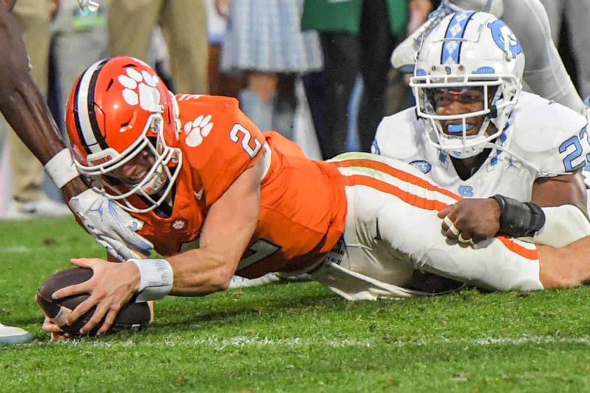 Nov 18, 2023; Clemson, South Carolina, USA; Clemson Tigers quarterback Cade Klubnik (2) dives past North Carolina Tar Heels linebacker Power Echols (23) for a touchdown during the second quarter at Memorial Stadium.