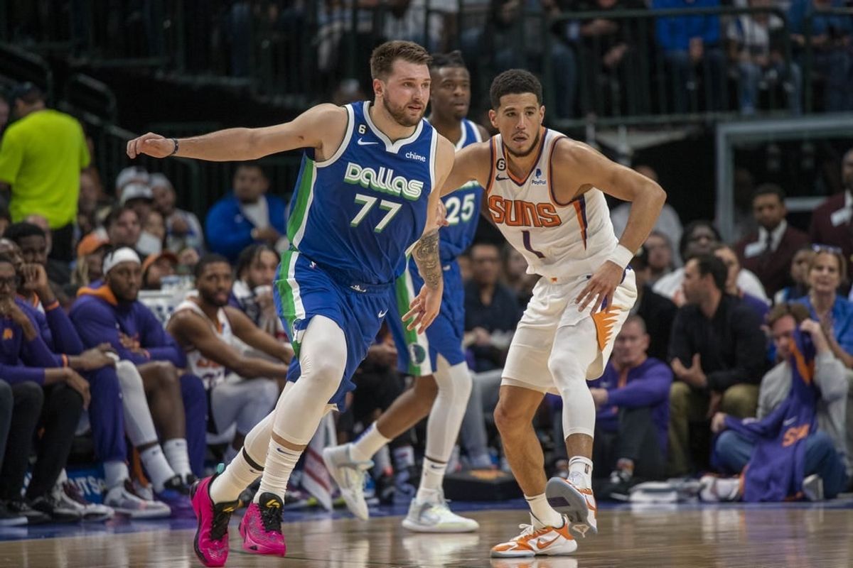 Dec 5, 2022; Dallas, Texas, USA; Phoenix Suns guard Devin Booker (1) and Dallas Mavericks guard Luka Doncic (77) in action during the game between the Dallas Mavericks and the Phoenix Suns at American Airlines Center.