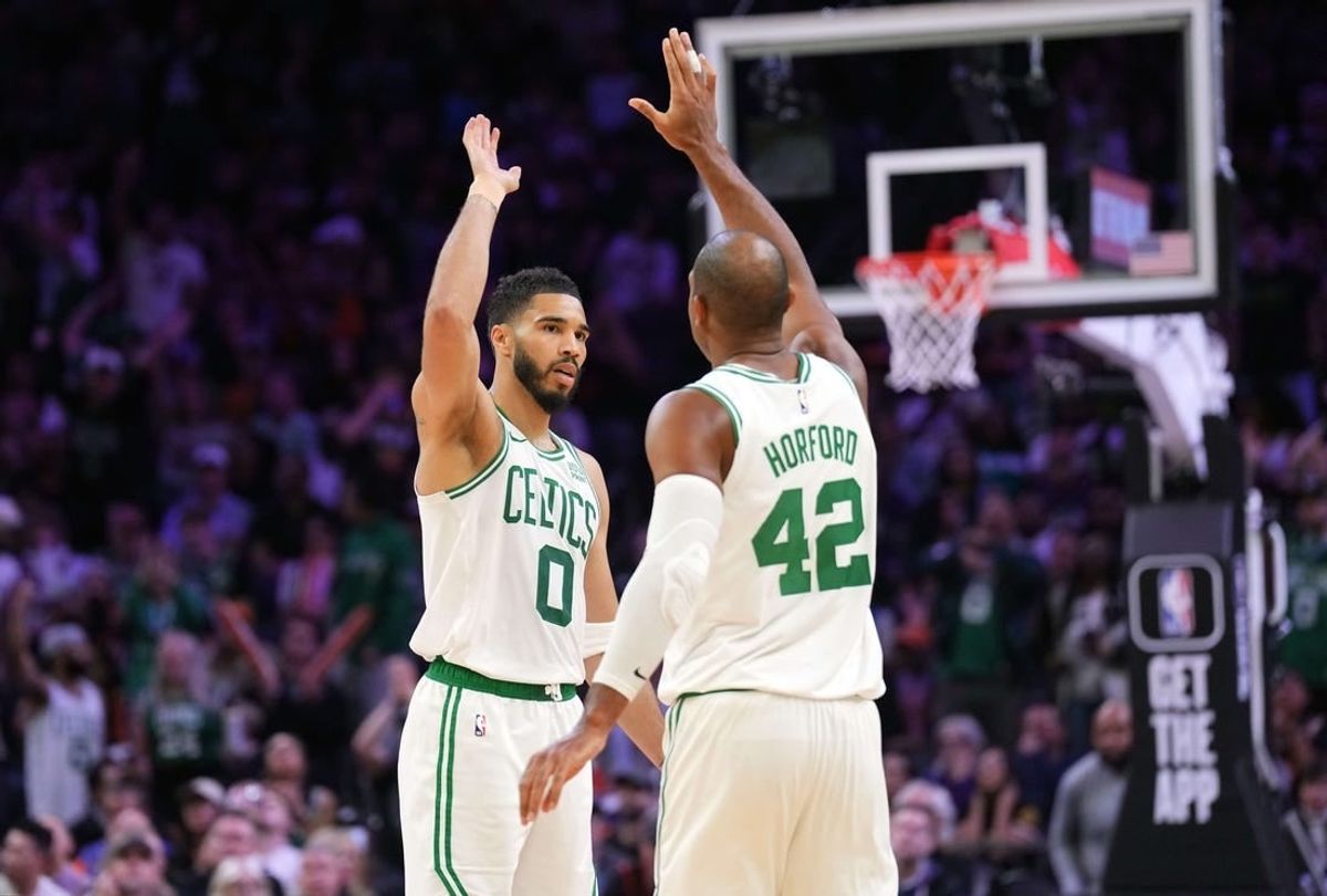 Mar 9, 2024; Phoenix, Arizona, USA; Boston Celtics forward Jayson Tatum (0) and Boston Celtics center Al Horford (42) slap hands during the second half of the game against the Phoenix Suns at Footprint Center.