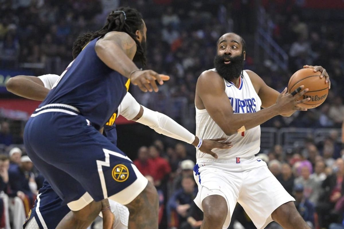 Apr 4, 2024; Los Angeles, California, USA;  Los Angeles Clippers guard James Harden (1) is defended by Denver Nuggets center DeAndre Jordan (6) in the first half at Crypto.com Arena.