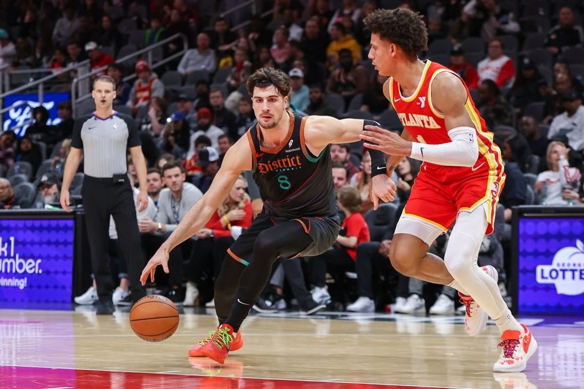 Jan 13, 2024; Atlanta, Georgia, USA; Washington Wizards forward Deni Avdija (8) drives on Atlanta Hawks forward Jalen Johnson (1) in the second half at State Farm Arena.