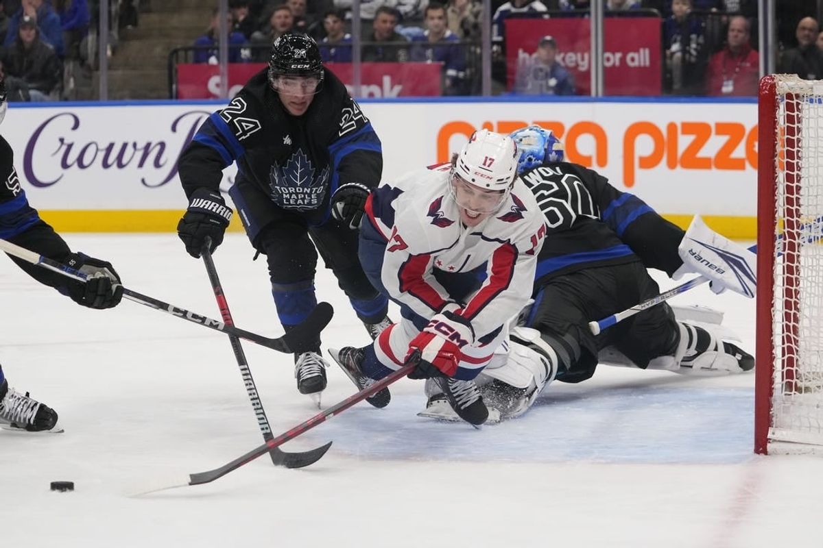 Mar 28, 2024; Toronto, Ontario, CAN; Toronto Maple Leafs forward Connor Dewar (24) knocks Washington Capitals forward Dylan Strome (17) off of the puck as he breaks in on Toronto Maple Leafs goaltender Joseph Woll (60) during the second period at Scotiabank Arena.