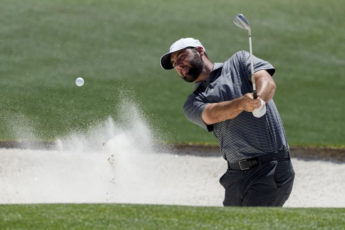 Apr 8, 2024; Augusta, Georgia, USA; Scottie Scheffler hits out of a bunker on no. 18 during a practice round for the Masters Tournament golf tournament at Augusta National Golf Club.