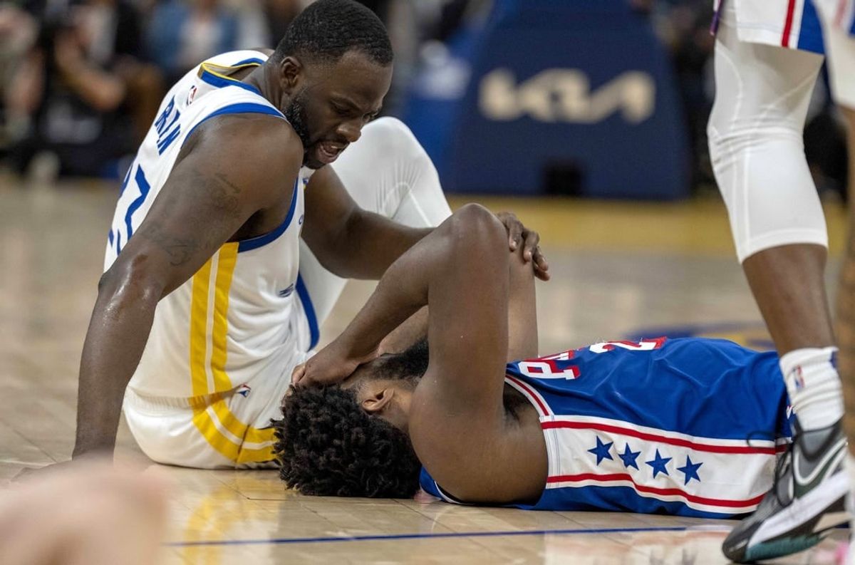 Jan 30, 2024; San Francisco, California, USA;  Golden State Warriors forward Draymond Green (23) checks on Philadelphia 76ers center Joel Embiid (21) after a play during the second quarter at Chase Center.