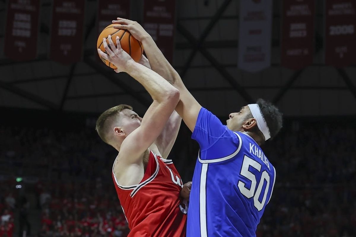 Dec 9, 2023; Salt Lake City, Utah, USA; Brigham Young Cougars center Aly Khalifa (50) blocks the shot of Utah Utes center Lawson Lovering (34) during the second half at Jon M. Huntsman Center.