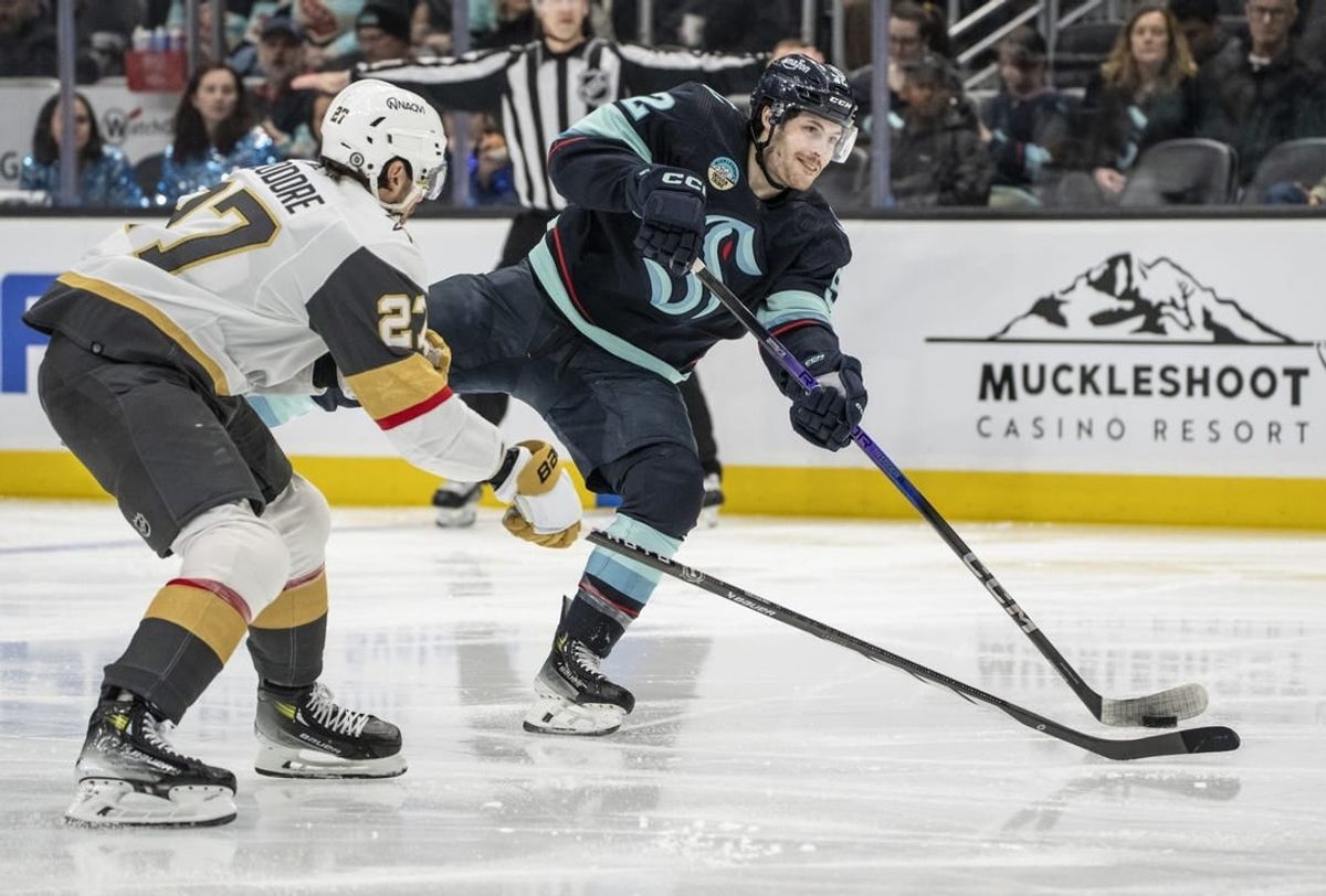Mar 12, 2024; Seattle, Washington, USA; Seattle Kraken forward Tye Kartye (52) takes a shot Vegas Golden Knights defenseman Shea Theodore (27) during the second period at Climate Pledge Arena.