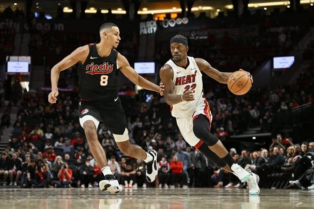 Feb 27, 2024; Portland, Oregon, USA; Miami Heat forward Jimmy Butler (22) drives to the basket during the second half against Portland Trail Blazers forward Kris Murray (8) at Moda Center.