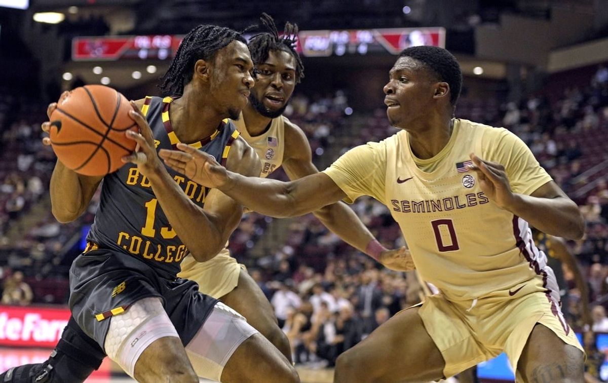 Feb 20, 2024; Tallahassee, Florida, USA; Boston College Eagles guard Donald Hand Jr. (13) is pressured by Florida State Seminoles guard Chandler Jackson (0) during the first half at Donald L. Tucker Center.