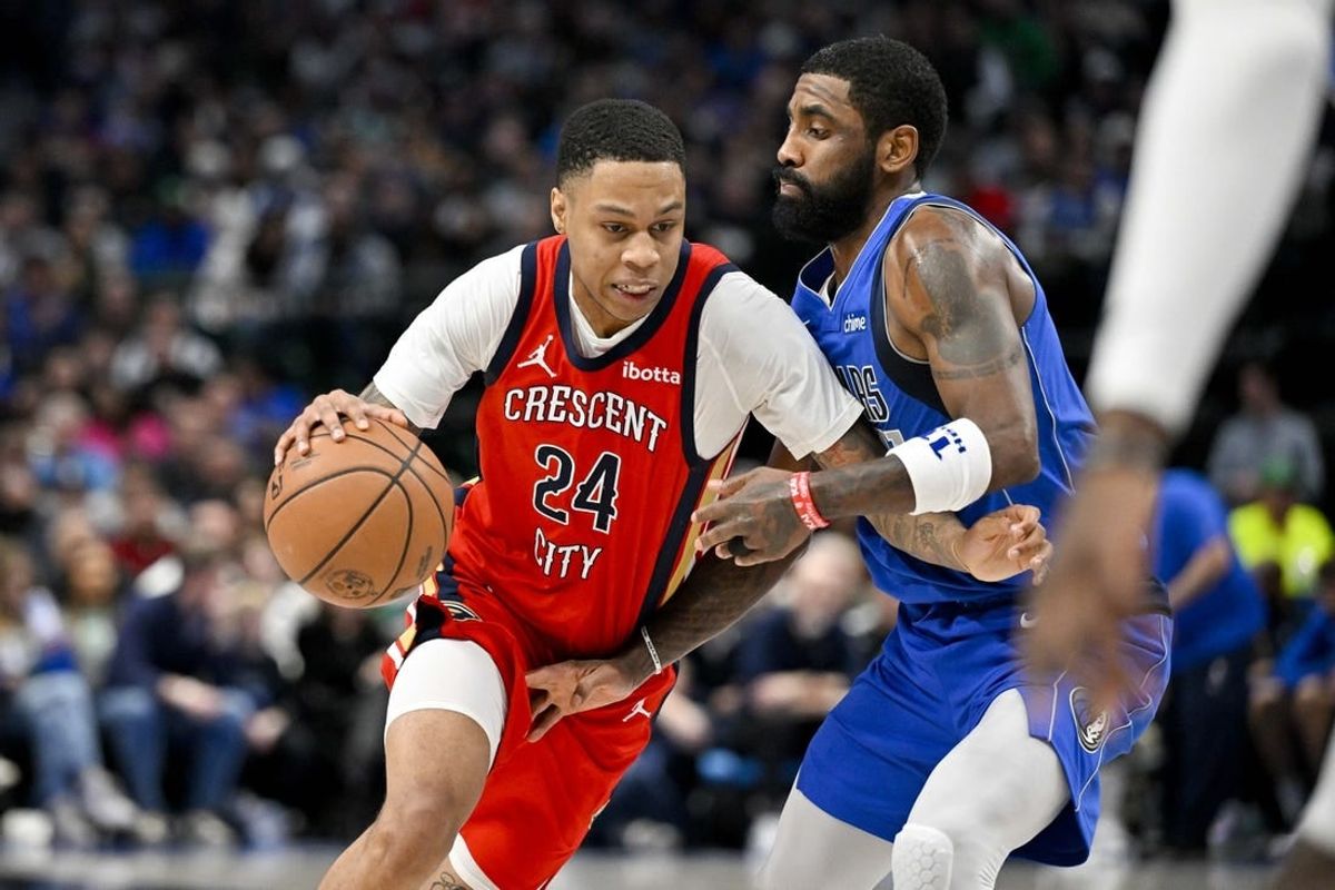 Jan 13, 2024; Dallas, Texas, USA; New Orleans Pelicans guard Jordan Hawkins (24) drives to the basket past Dallas Mavericks guard Kyrie Irving (11) during the second half at the American Airlines Center.