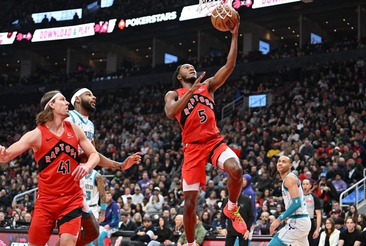 Mar 3, 2024; Toronto, Ontario, CAN;  Toronto Raptors guard Immanuel Quickley (5) scores on a layup against the Charlotte Hornets in the first half at Scotiabank Arena.
