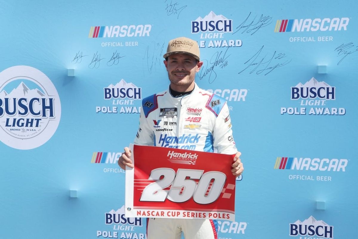 Apr 13, 2024; Fort Worth, Texas, USA;  NASCAR Cup Series driver Kyle Larson (5) celebrates Hendrick Motor Sports 250th NASCAR Cup Series pole after qualifying for the NASCAR Cup Series AutoTrader EchoPark Automotive 400 at Texas Motor Speedway.