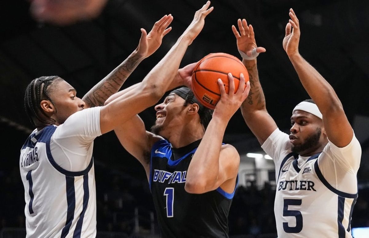 Buffalo Bulls forward Sy Chatman (1) attempts to push past Butler Bulldogs guard Posh Alexander (5) and Butler Bulldogs forward Jalen Thomas (1) on Tuesday, Dec. 5, 2023, during the game at Hinkle Fieldhouse in Indianapolis.