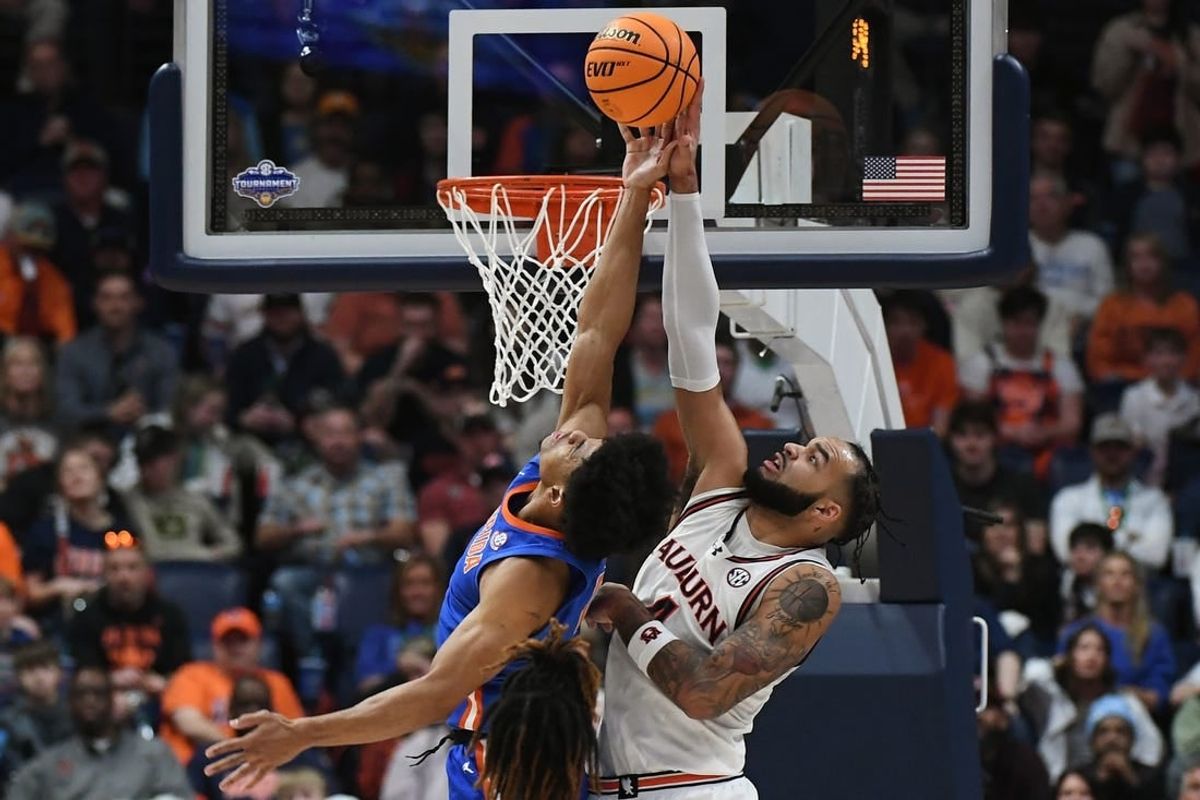 Mar 17, 2024; Nashville, TN, USA; Auburn Tigers forward Johni Broome (4) blocks Florida Gators guard Zyon Pullin (0) in the first half in the SEC Tournament championship game at Bridgestone Arena.