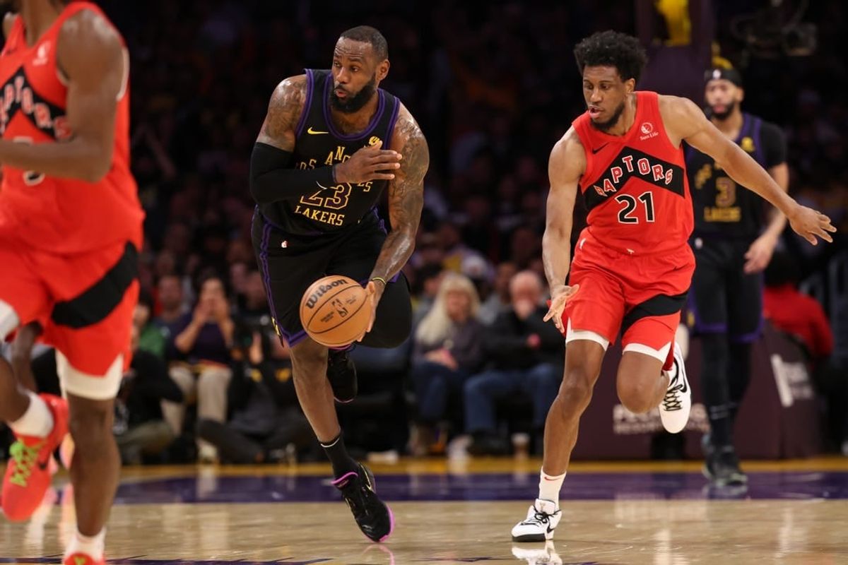 Jan 9, 2024; Los Angeles, California, USA; Los Angeles Lakers forward LeBron James (23) picks up a loose ball ahead of Toronto Raptors forward Thaddeus Young (21) during the second quarter at Crypto.com Arena.