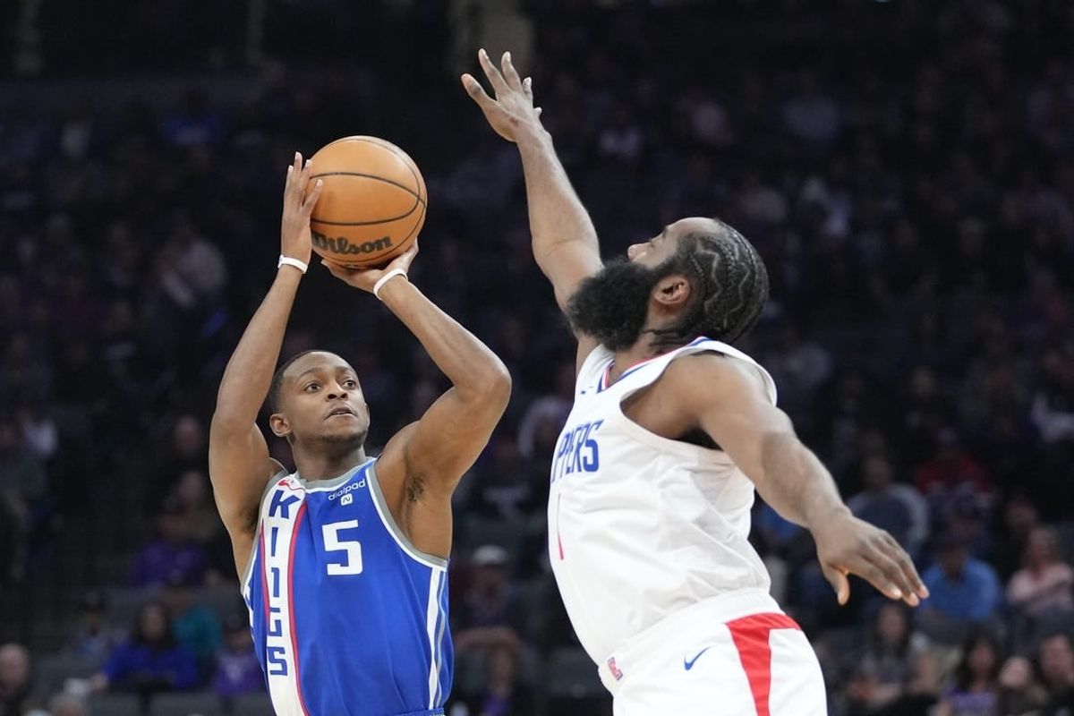 November 29, 2023; Sacramento, California, USA; Sacramento Kings guard De'Aaron Fox (5) shoots the basketball against LA Clippers guard James Harden (1) during the first quarter at Golden 1 Center.