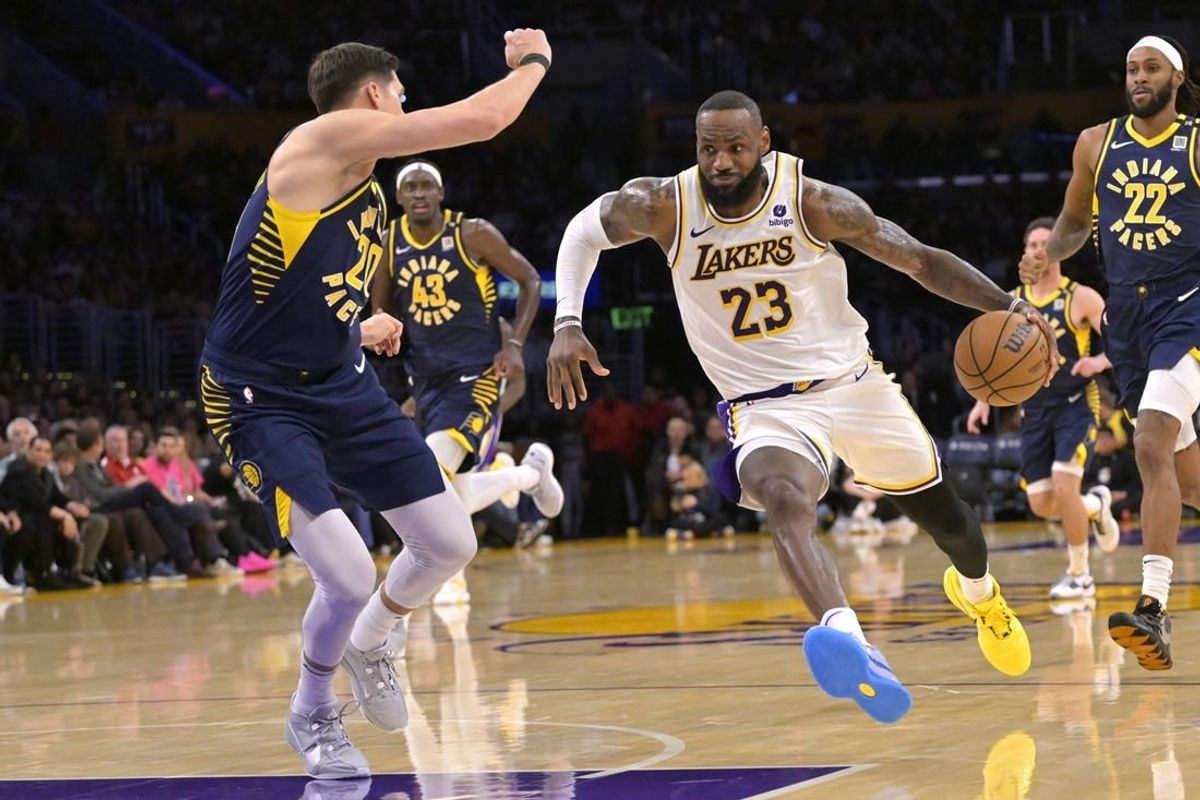 Mar 24, 2024; Los Angeles, California, USA;   Los Angeles Lakers forward LeBron James (23) drives past Indiana Pacers forward Doug McDermott (20) in the second half at Crypto.com Arena.