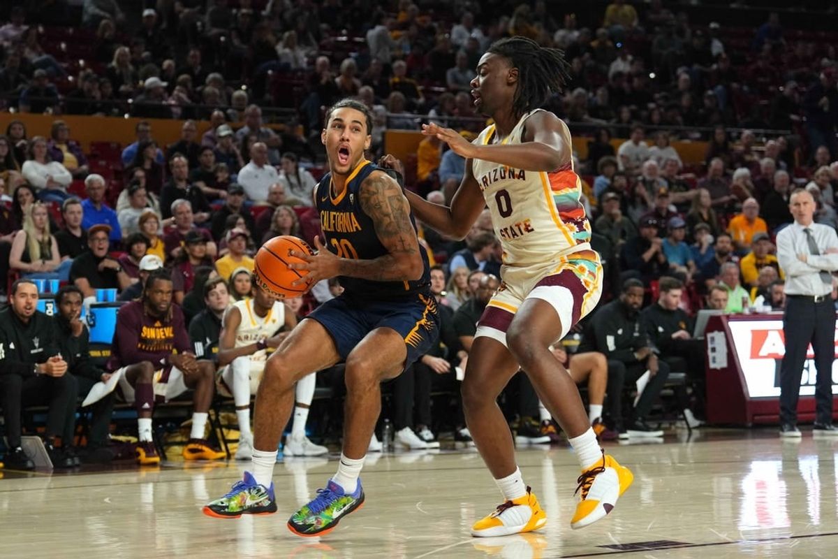 Feb 3, 2024; Tempe, Arizona, USA; California Golden Bears guard Jaylon Tyson (20) drives against Arizona State Sun Devils guard Kamari Lands (0) during the first half at Desert Financial Arena.