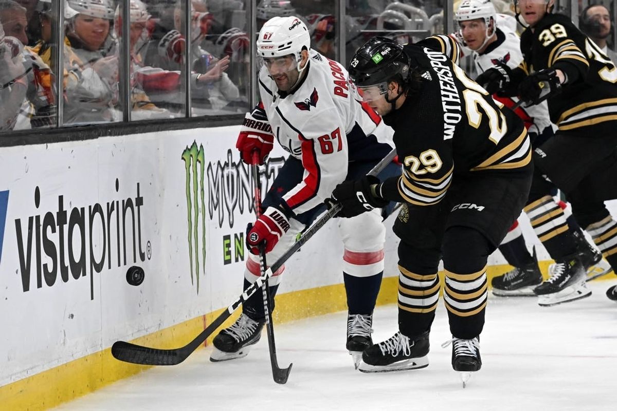 Feb 10, 2024; Boston, Massachusetts, USA; Washington Capitals left wing Max Pacioretty (67) and Boston Bruins defenseman Derek Forbort (28) battle for the puck during the second period at the TD Garden.