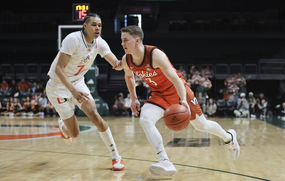 Feb 3, 2024; Coral Gables, Florida, USA; Virginia Tech Hokies guard Sean Pedulla (3) drives to the basket past Miami Hurricanes guard Kyshawn George (7) during the first half at Watsco Center.