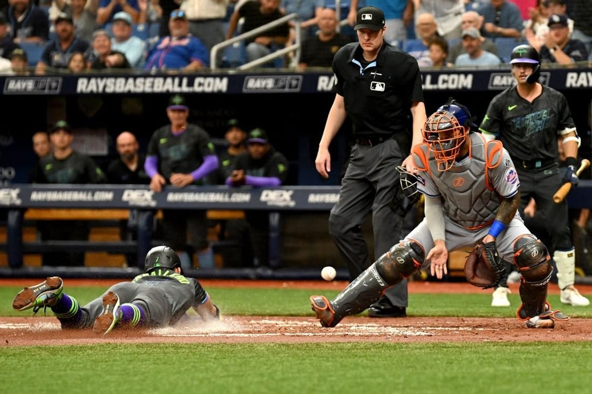 May 5, 2024; St. Petersburg, Florida, USA; New York Mets catcher Omar Narvaez (2) waits for the ball as Tampa Bay Rays shortstop Jose Caballero (7) slides to score a run in the second inning at Tropicana Field.