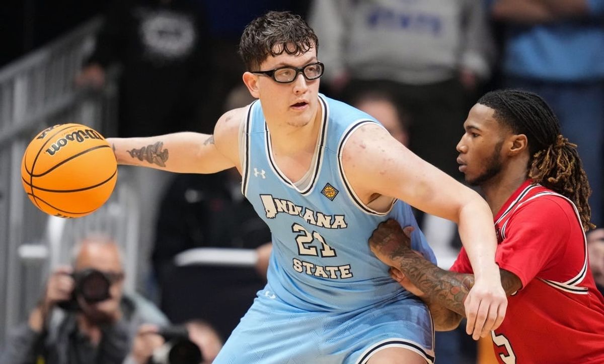 Indiana State Sycamores center Robbie Avila (21) goes in for a lay-up against Utah Utes guard Deivon Smith (5) on Tuesday, April 2, 2024, during the NIT semifinals at Hinkle Fieldhouse in Indianapolis. The Indiana State Sycamores defeated the Utah Utes, 100-90.