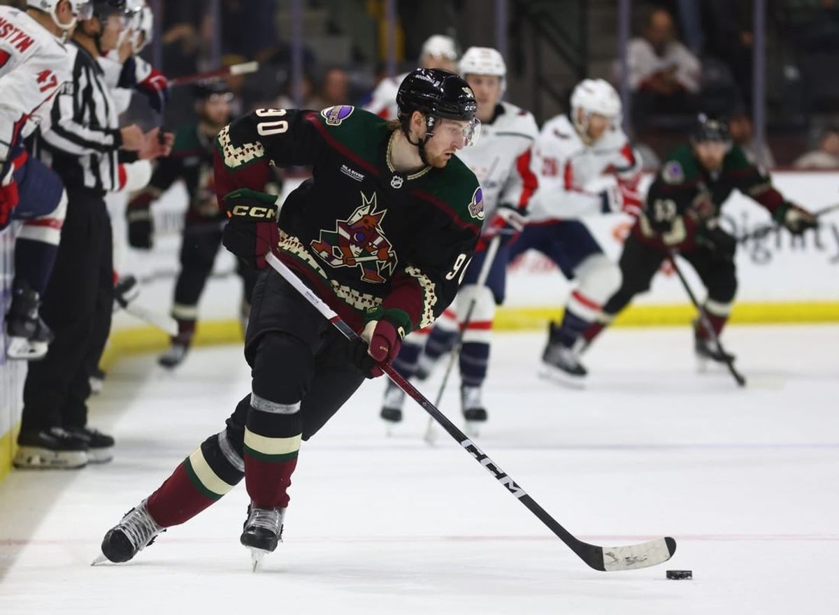 Dec 4, 2023; Tempe, Arizona, USA; Arizona Coyotes defenseman J.J. Moser (90) moves the puck against the Washington Capitals in the third period at Mullett Arena.
