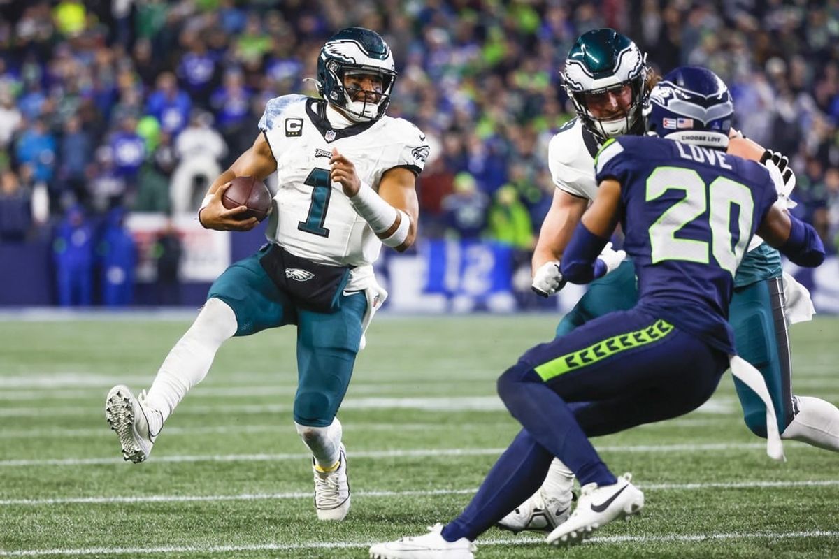 Dec 18, 2023; Seattle, Washington, USA; Philadelphia Eagles quarterback Jalen Hurts (1) rushes against the Seattle Seahawks during the second quarter at Lumen Field.
