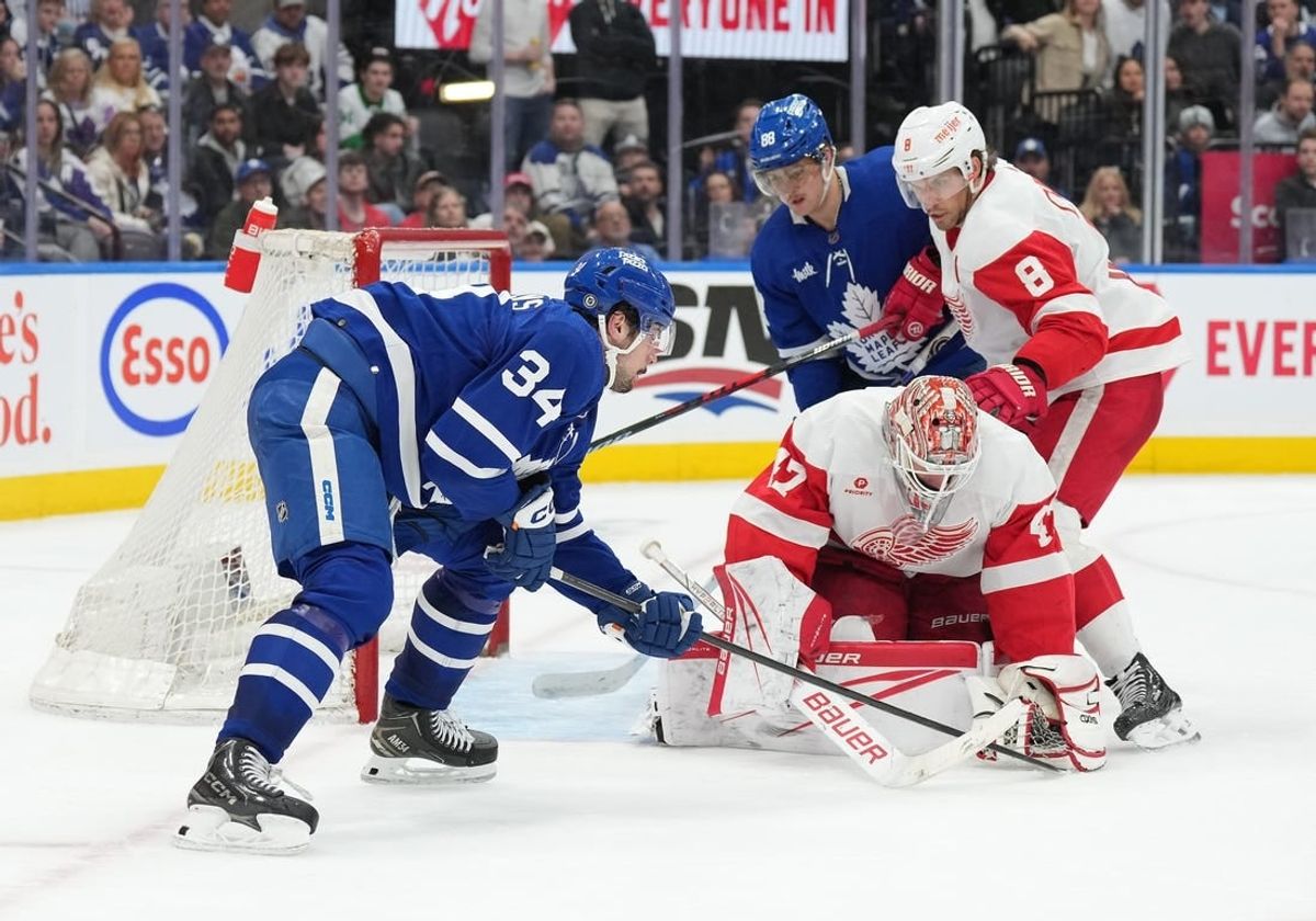 Apr 13, 2024; Toronto, Ontario, CAN; Toronto Maple Leafs center Auston Matthews (34) fights for the rebound as Detroit Red Wings goaltender James Reimer (47) freezes the puck during the third period at Scotiabank Arena.