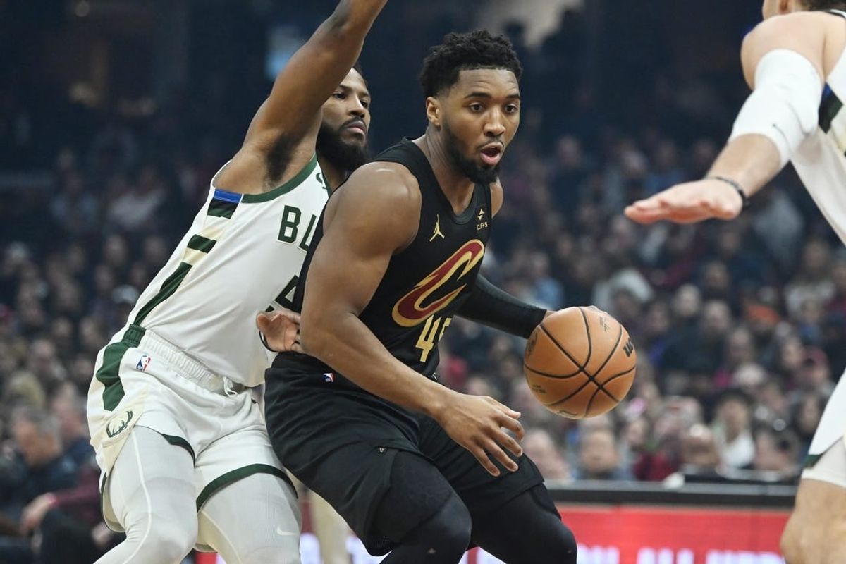 Jan 17, 2024; Cleveland, Ohio, USA; Cleveland Cavaliers guard Donovan Mitchell (45) drives to the basket against Milwaukee Bucks guard Malik Beasley (5) during the first half at Rocket Mortgage FieldHouse.