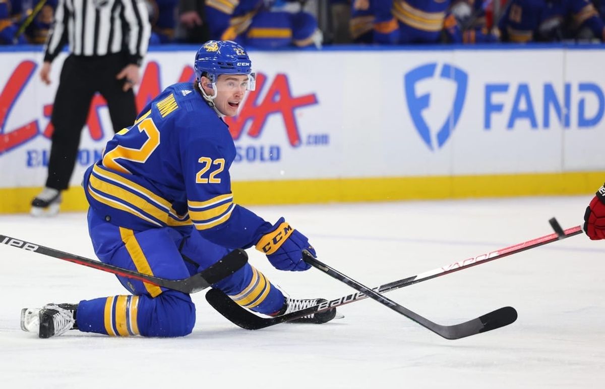Apr 8, 2023; Buffalo, New York, USA;  Buffalo Sabres right wing Jack Quinn (22) makes a pass as he falls during the second period against the Carolina Hurricanes at KeyBank Center.