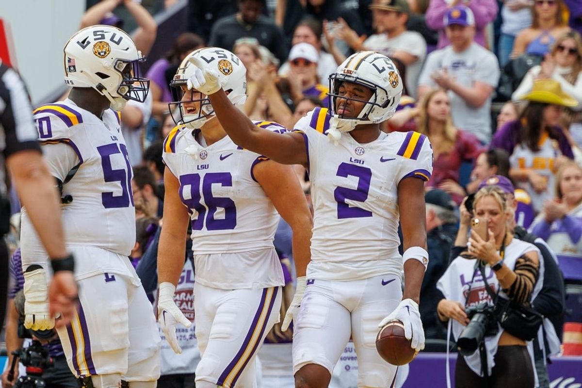 Nov 25, 2023; Baton Rouge, Louisiana, USA;  LSU Tigers wide receiver Kyren Lacy (2) points to quarterback Jayden Daniels (5) after scoring a touchdown against the Texas A&M Aggies during the second half at Tiger Stadium.