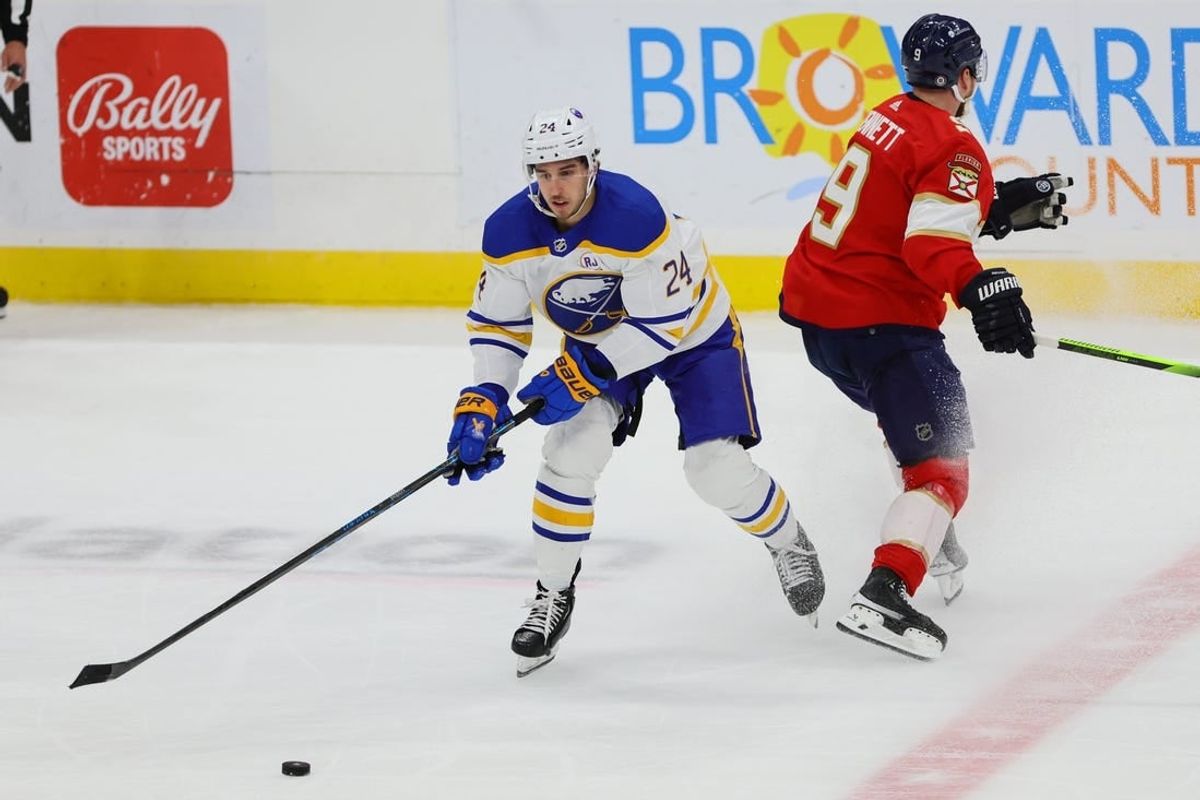 Apr 13, 2024; Sunrise, Florida, USA; Buffalo Sabres center Dylan Cozens (24) moves the puck past Florida Panthers center Sam Bennett (9) during the third period at Amerant Bank Arena.