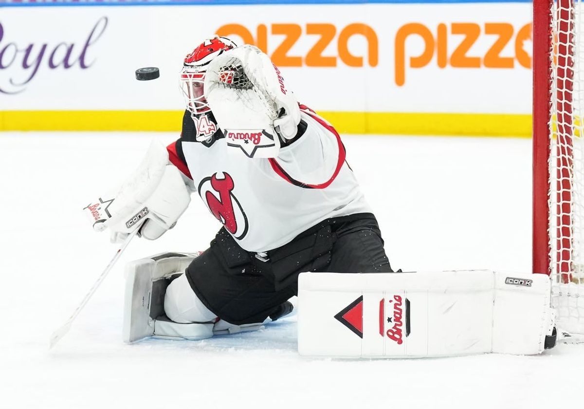 Mar 26, 2024; Toronto, Ontario, CAN; New Jersey Devils goaltender Jake Allen (34) attempts to stop the puck against the Toronto Maple Leafs during the first period at Scotiabank Arena.
