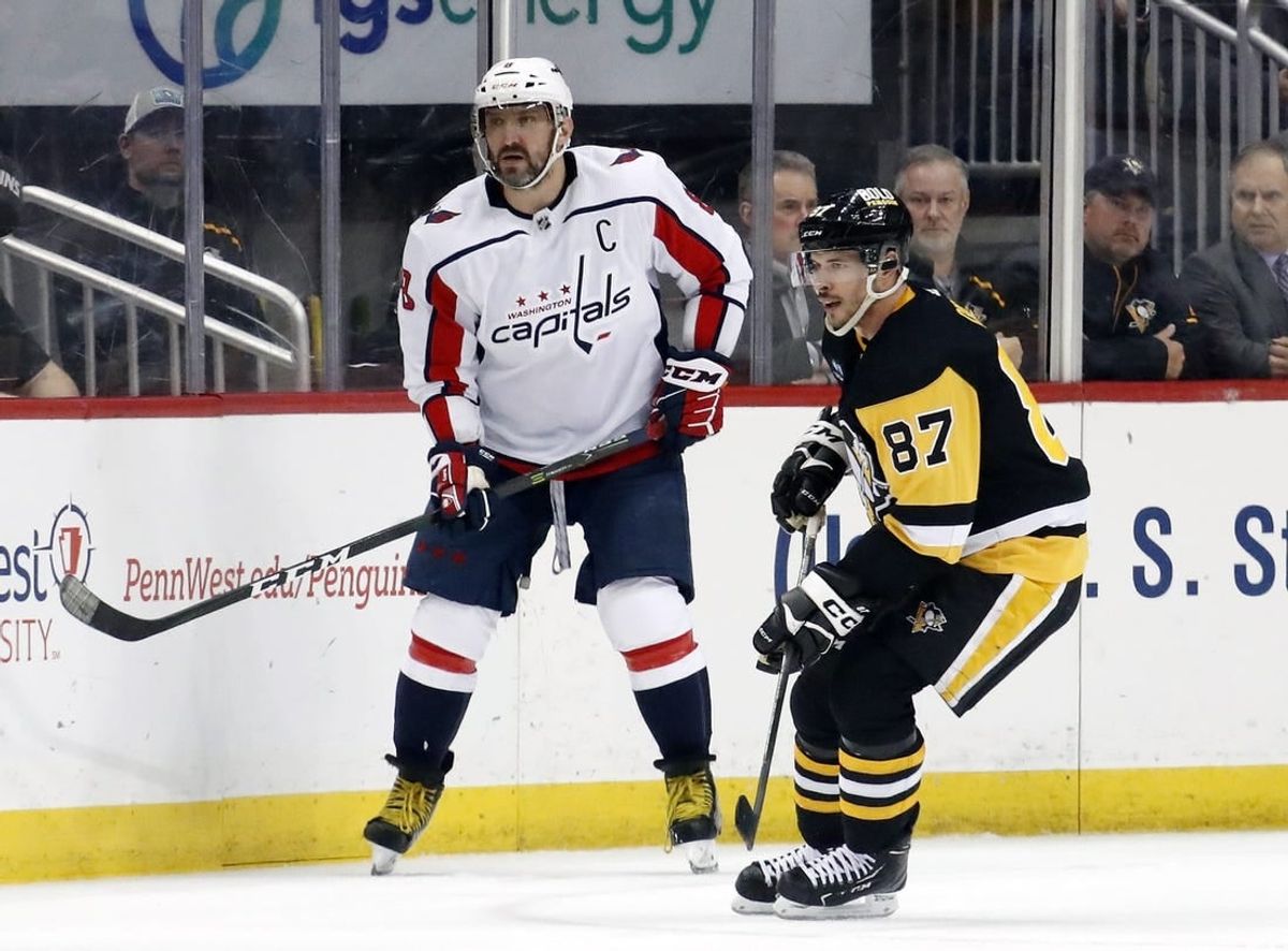 Mar 25, 2023; Pittsburgh, Pennsylvania, USA;  Washington Capitals left wing Alex Ovechkin (8) and Pittsburgh Penguins center Sidney Crosby (87) look for the puck during the third period at PPG Paints Arena. Pittsburgh won 4-3.