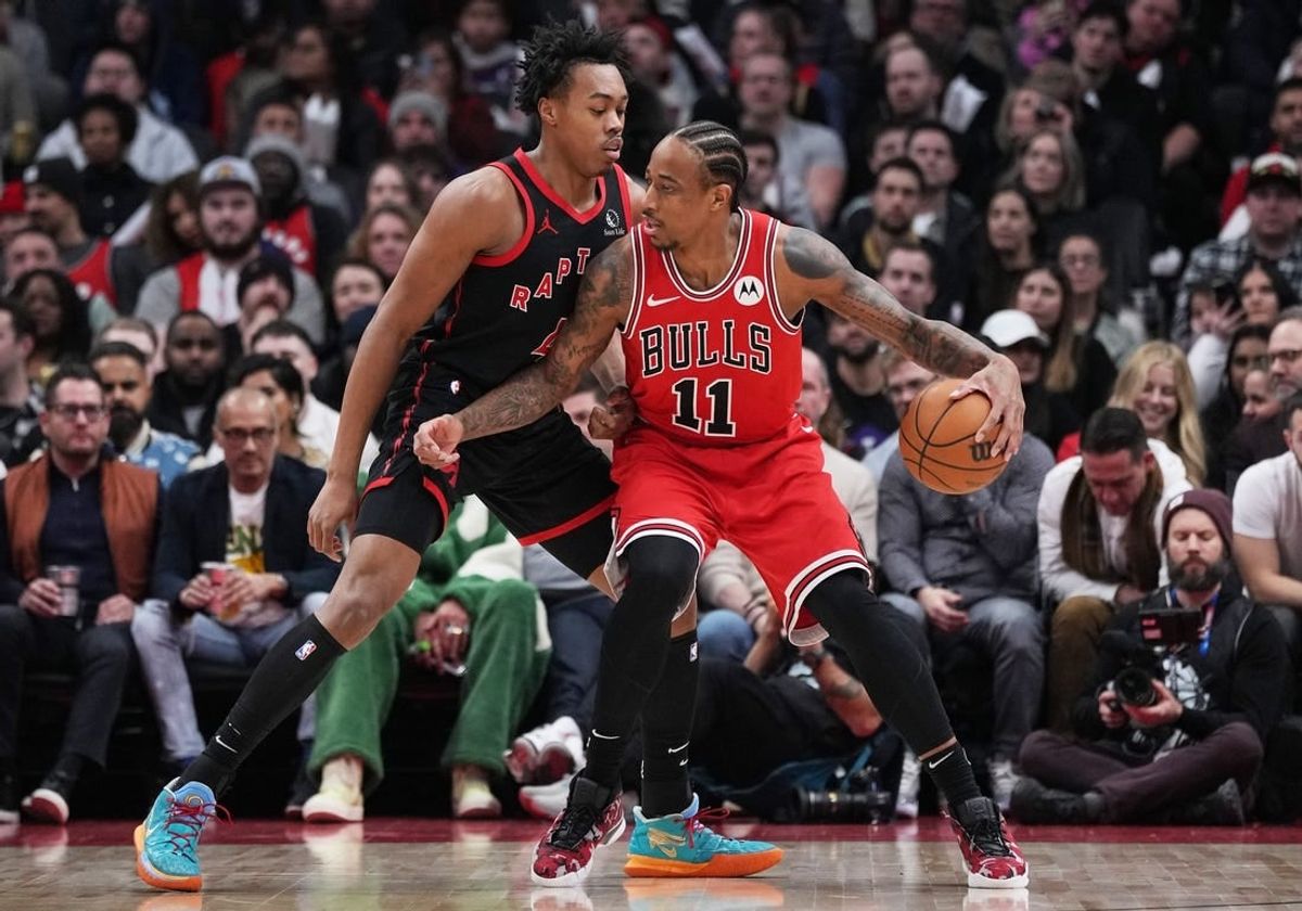Jan 18, 2024; Toronto, Ontario, CAN; Chicago Bulls forward DeMar DeRozan (11) controls the ball as Toronto Raptors forward Scottie Barnes (4) tries to defend during the second quarter at Scotiabank Arena.