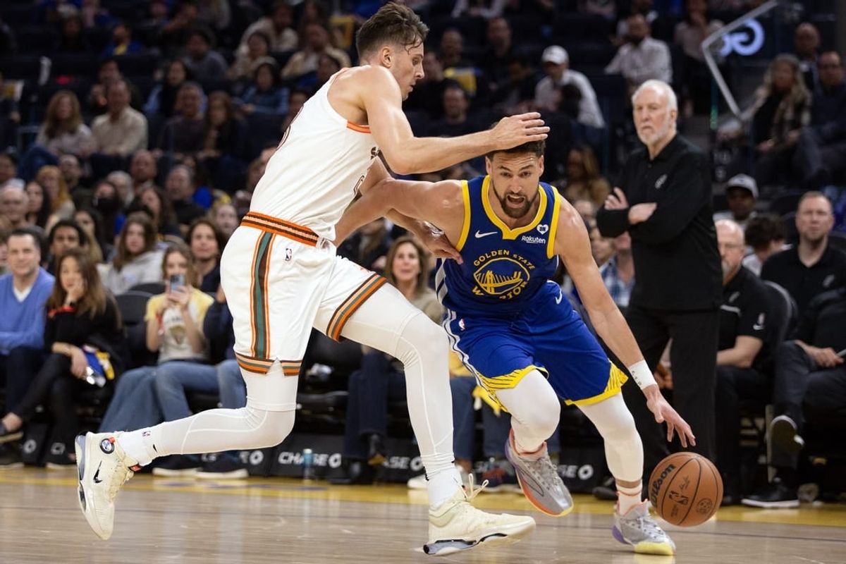 Mar 9, 2024; San Francisco, California, USA; Golden State Warriors guard Klay Thompson (11) drives around San Antonio Spurs forward Zach Collins (23) during the second quarter at Chase Center.