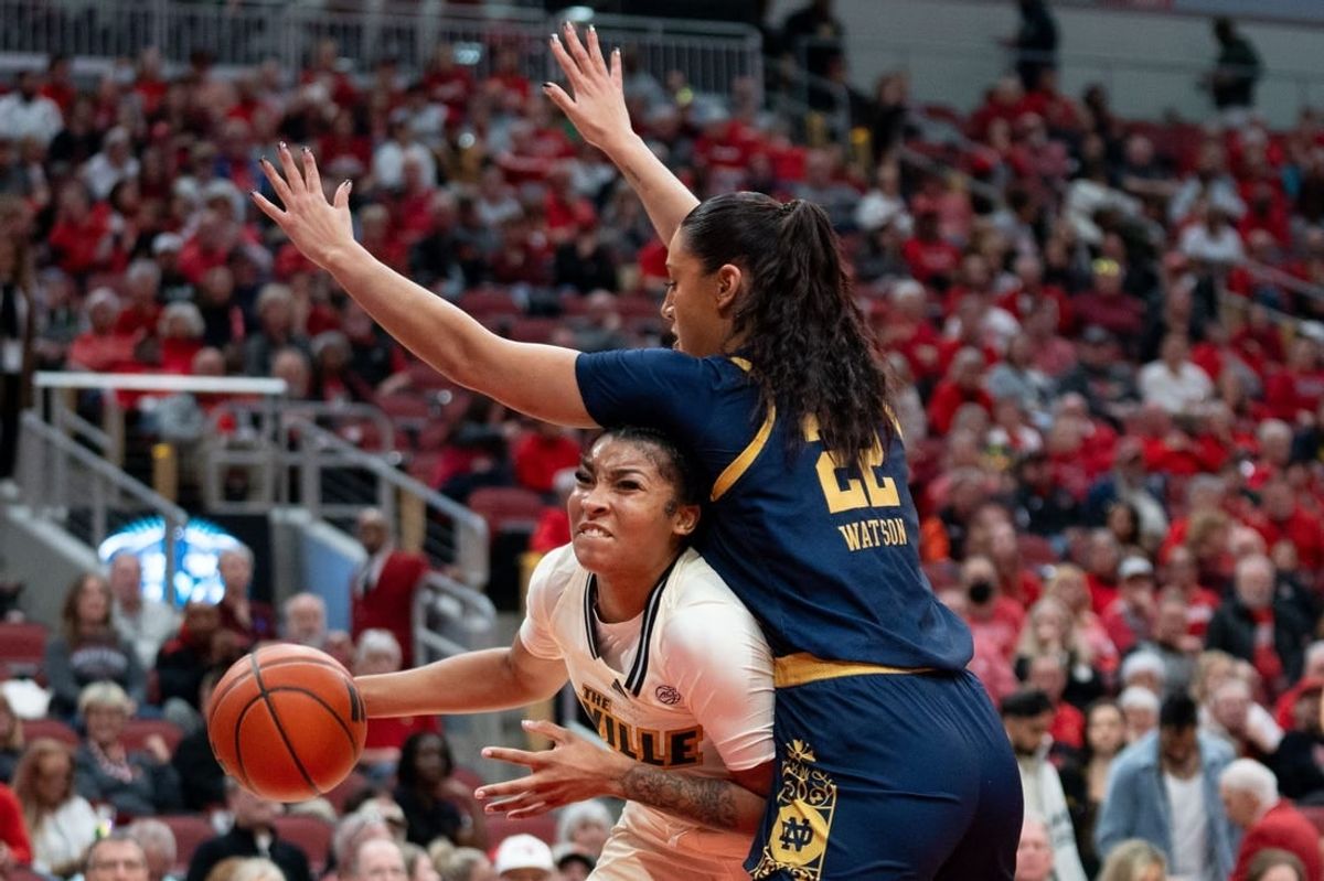 Louisville Cardinals forward Nyla Harris (2) attempts to get around Notre Dame Fighting Irish forward Kylee Watson (22) for a layup during their game on Thursday, Feb. 8, 2024 at KFC YUM Center.