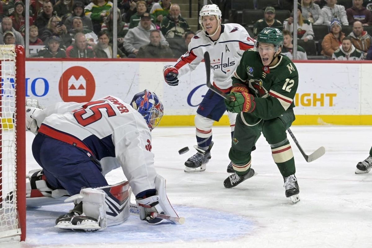Jan 23, 2024; Saint Paul, Minnesota, USA;  Minnesota Wild forward Matt Boldy (12) shoots the puck wide of the net of Washington Capitals goalie Darcy Kuemper (35) during the second period at Xcel Energy Center.