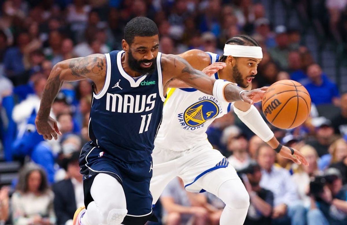 Apr 5, 2024; Dallas, Texas, USA; Dallas Mavericks guard Kyrie Irving (11) dribbles as Golden State Warriors guard Moses Moody (4) defends during the first quarter at American Airlines Center.