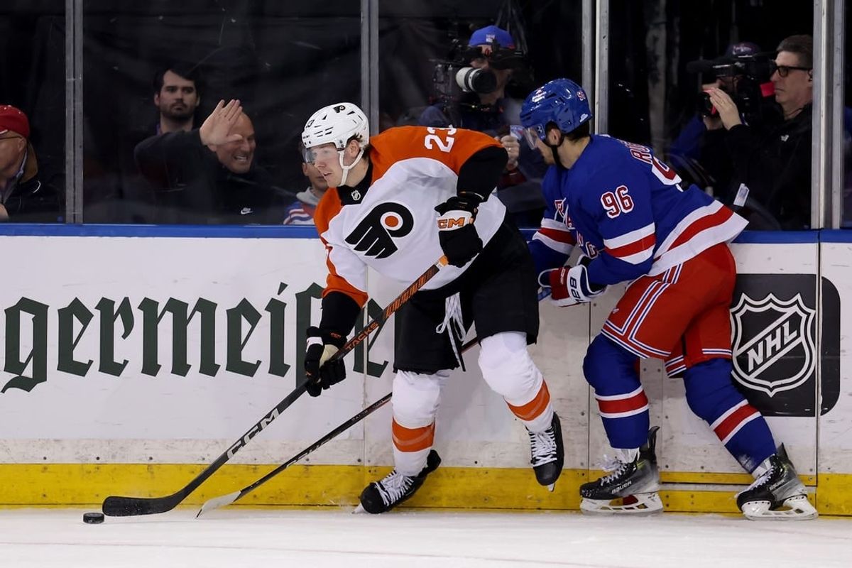 Mar 26, 2024; New York, New York, USA; Philadelphia Flyers defenseman Ronnie Attard (23) looks to pass the puck against New York Rangers center Jack Roslovic (96) during the first period at Madison Square Garden.