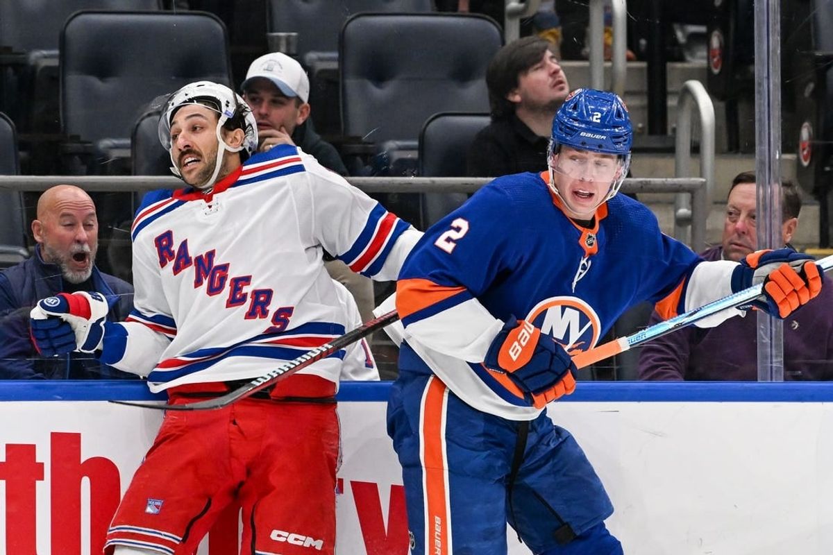 Apr 9, 2024; Elmont, New York, USA; New York Rangers center Vincent Trocheck (16) and New York Islanders defenseman Mike Reilly (2) collide along the boards during the second period at UBS Arena.