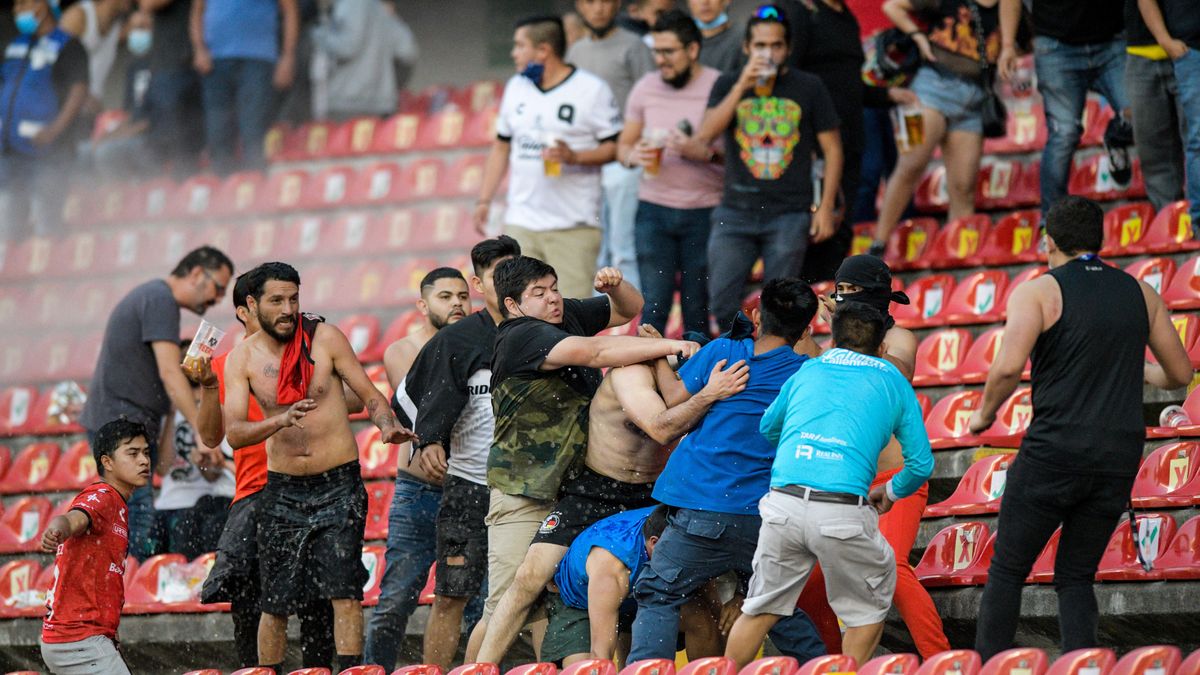 Fans brawl in the stands at yesterday’s Liga MX match.