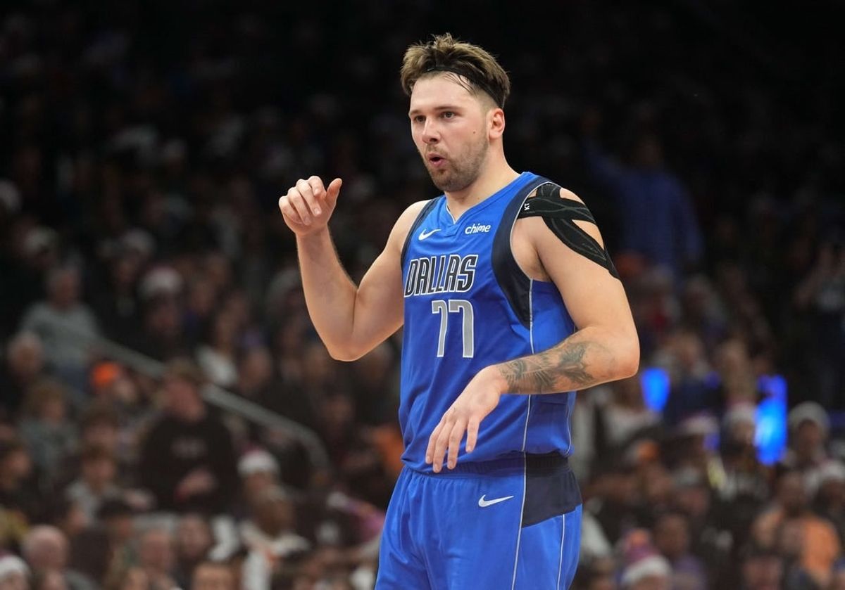 Dec 25, 2023; Phoenix, Arizona, USA; Dallas Mavericks guard Luka Doncic (77) celebrates against the Phoenix Suns after scoring a basket that put him over 10,000 points for his career during the first half of the game at Footprint Center.