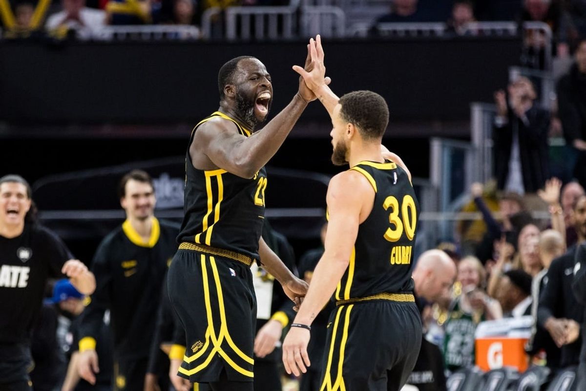 Feb 10, 2024; San Francisco, California, USA; Golden State Warriors center Draymond Green (23) and guard Stephen Curry (30) celebrate after scoring against the Phoenix Suns during the second half at Chase Center.