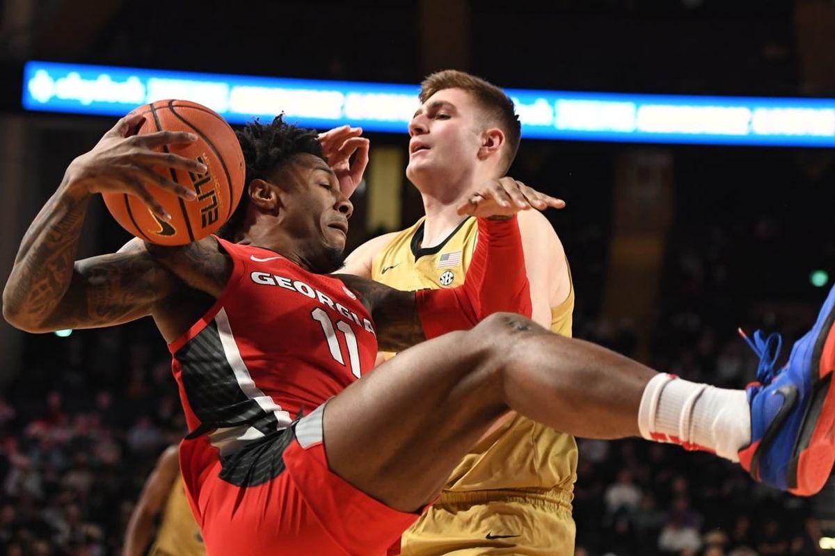 Feb 21, 2024; Nashville, Tennessee, USA; Georgia Bulldogs guard Justin Hill (11) grabs a rebound against Vanderbilt Commodores forward Carter Lang (35) during the first half at Memorial Gymnasium.